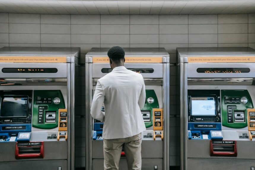 Business professional using a metro ticket machine at a transit station.